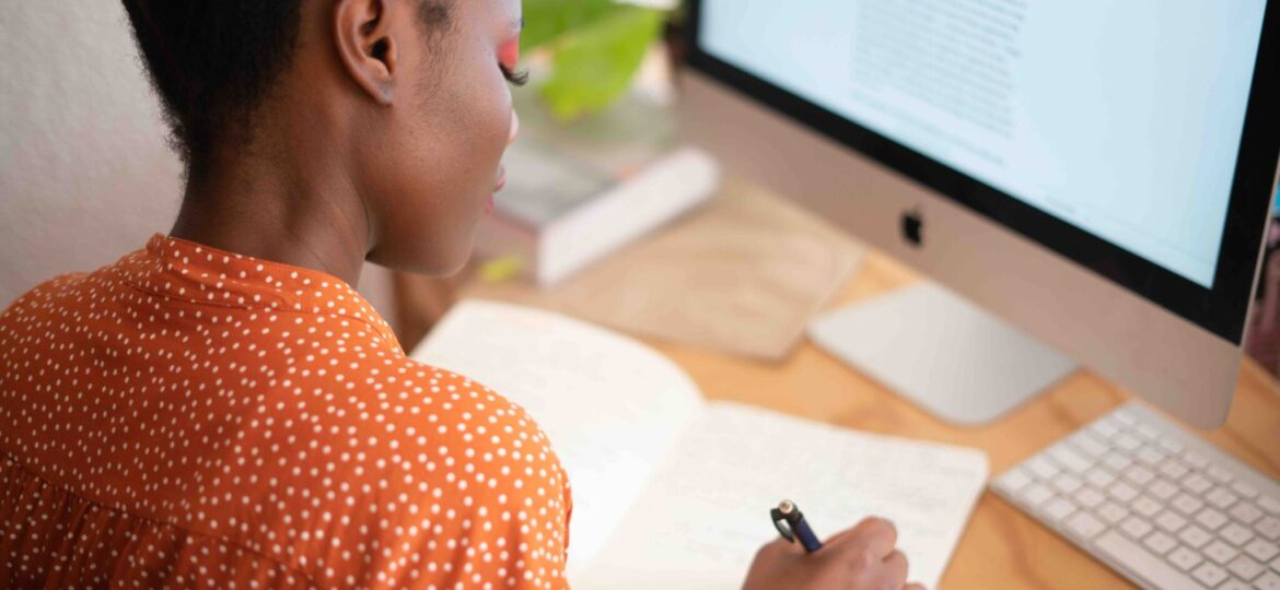 woman-writing-on-her-notebook-3059747